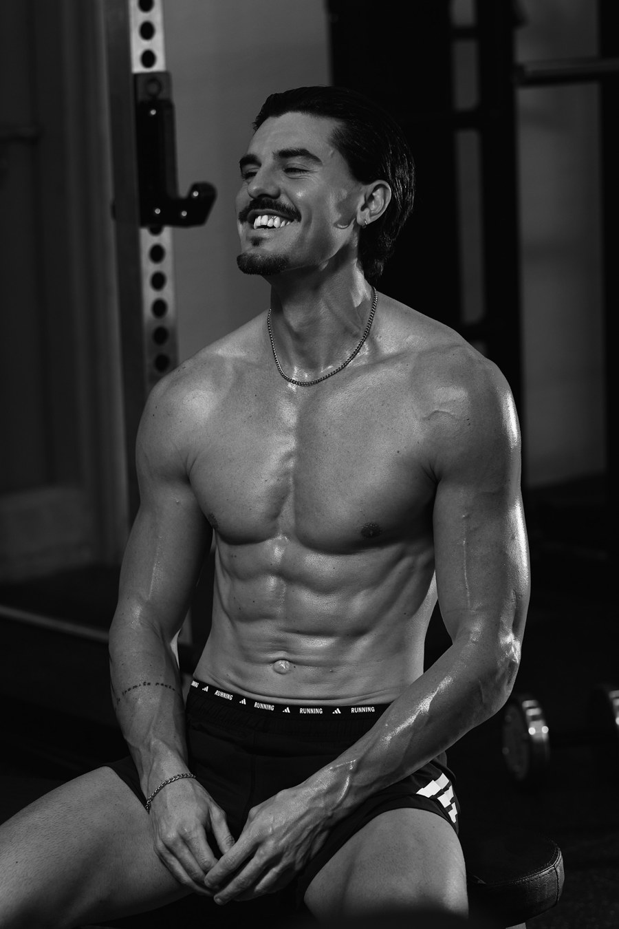 Robbie sitting in the gym, laughing